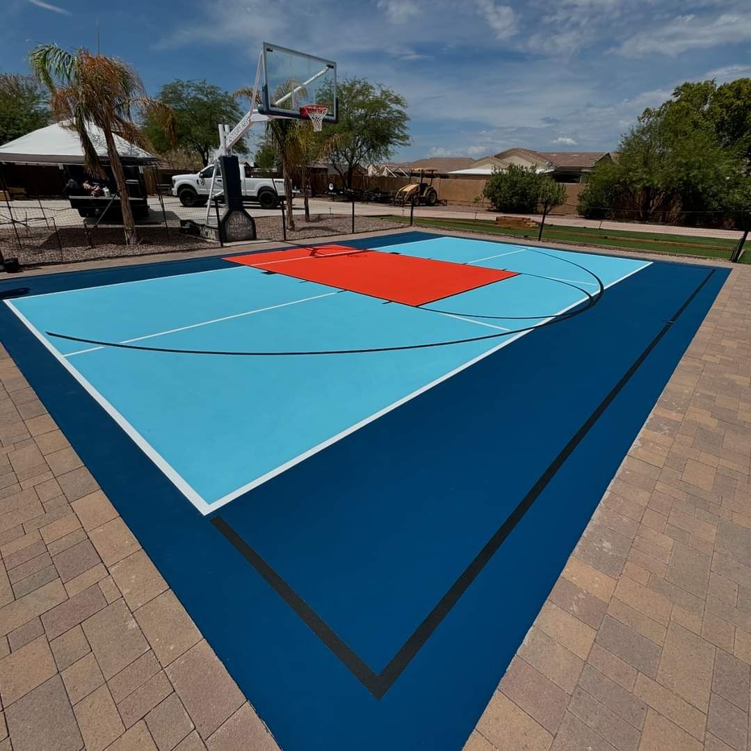 Outdoor basketball court with fresh blue and red sport surface coating