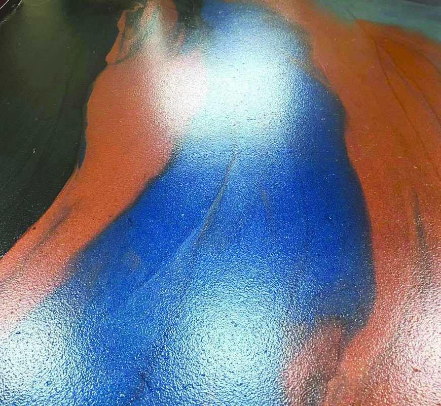 Metallic epoxy floor in residential garage with marbled brown and cream finish