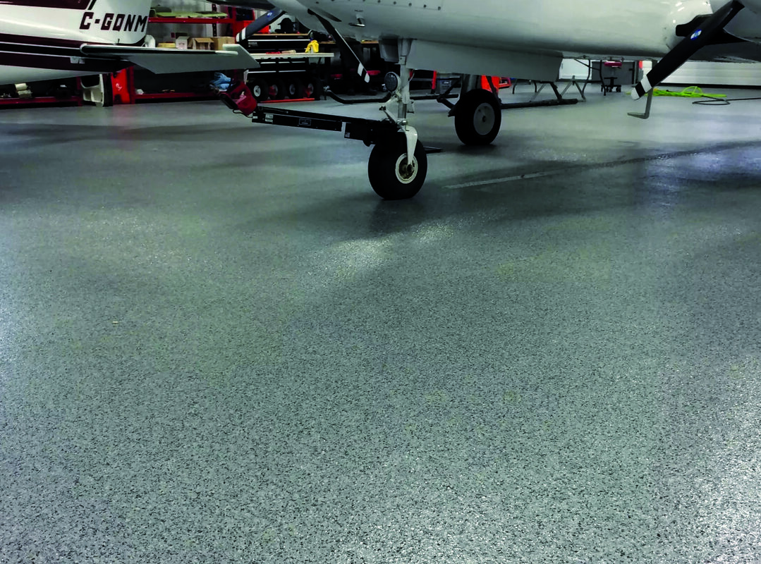 Residential garage floor with premium gray and white decorative vinyl flake epoxy coating