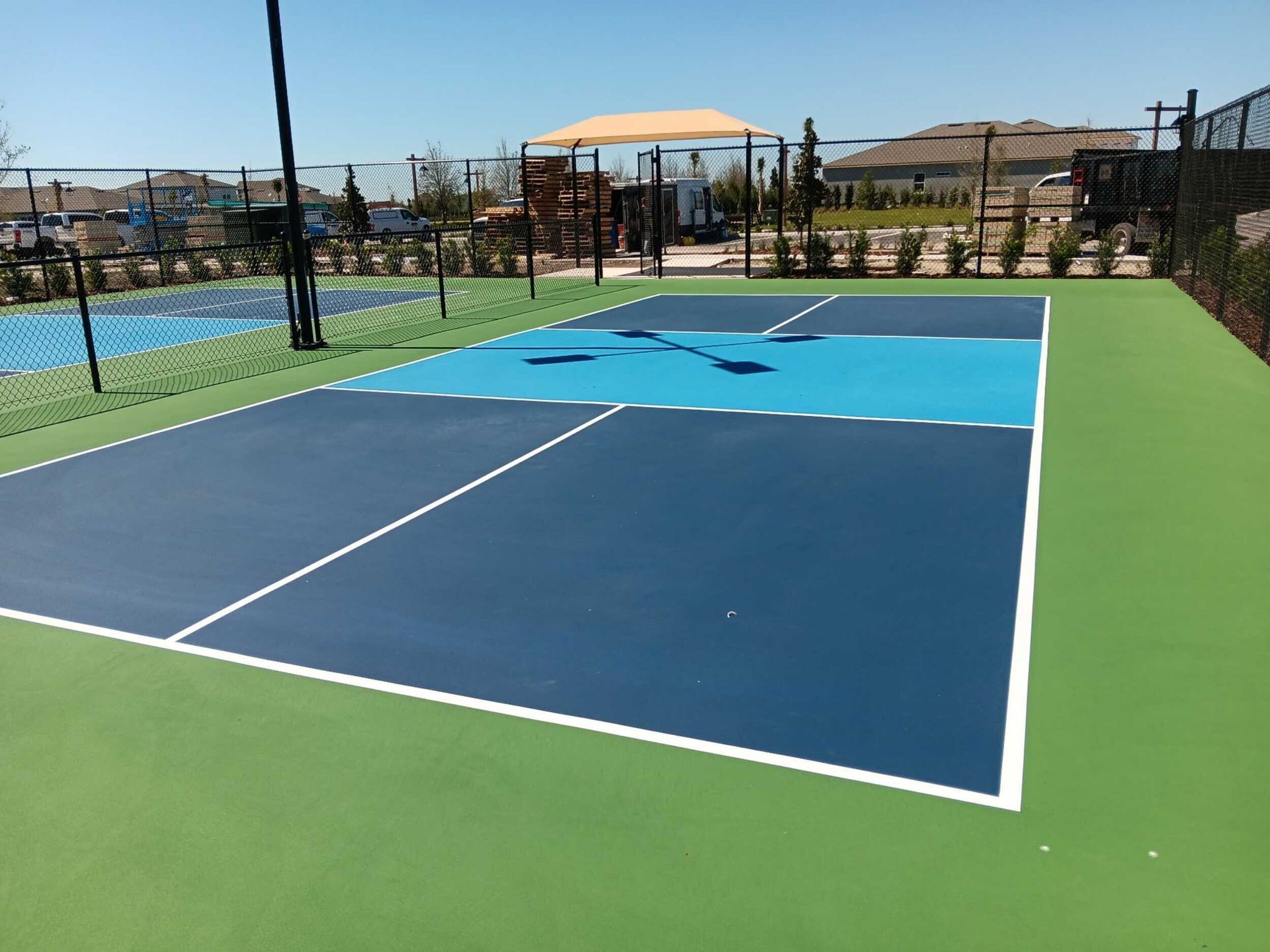 Vibrant pickleball court with blue playing surface and crisp white lines