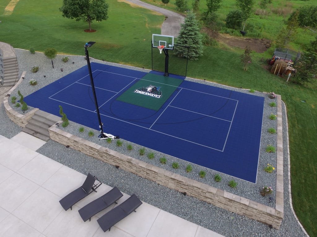 Four-court outdoor pickleball facility with blue and green SportMaster acrylic coating, nets, LED lighting, and chain link fencing