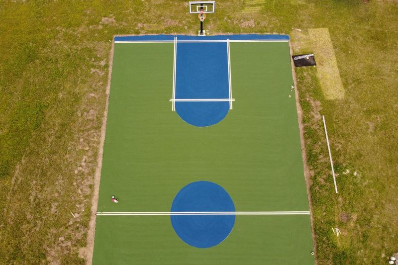 Overhead of crew measuring and taping the free-throw lane