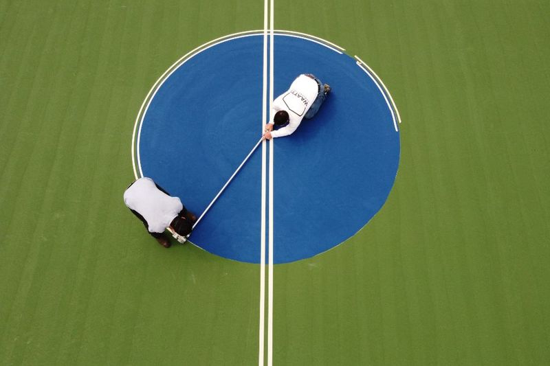 Overhead of crew taping the center circle