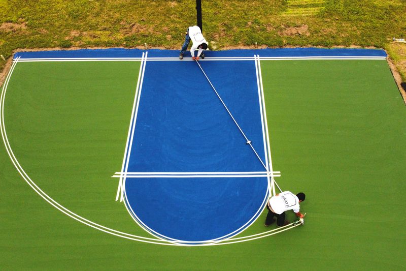 Overhead of crew striping the lane lines