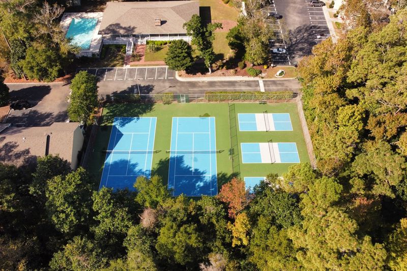 Wide aerial of the court complex among trees