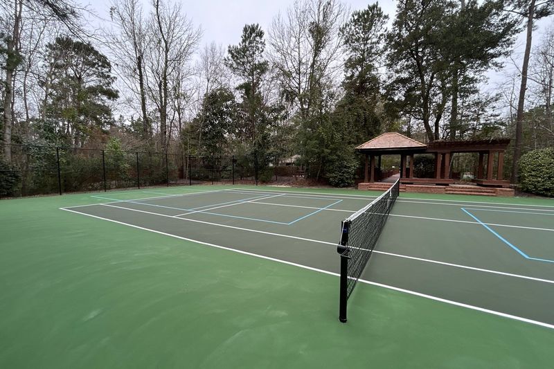 Court seen from the baseline with new net and pavilion behind