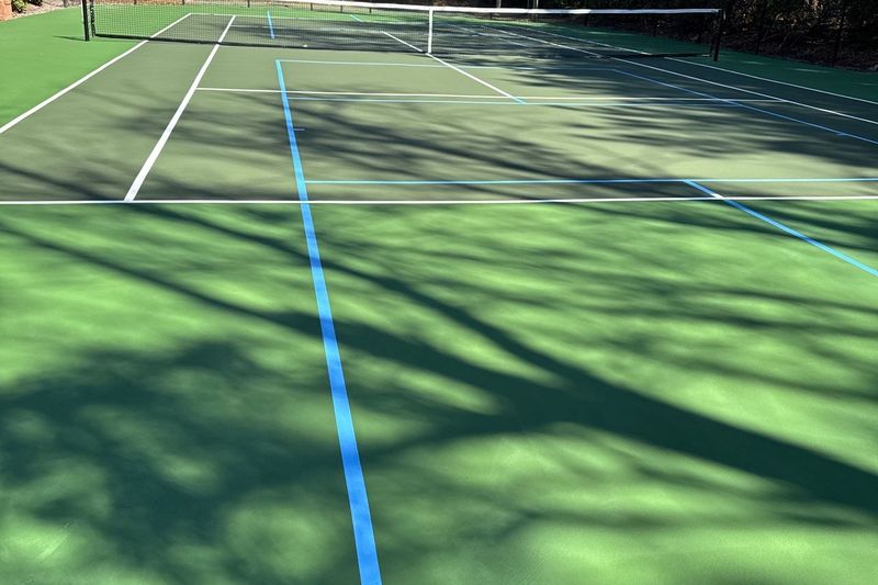 Detail of white tennis lines and blue pickleball lines