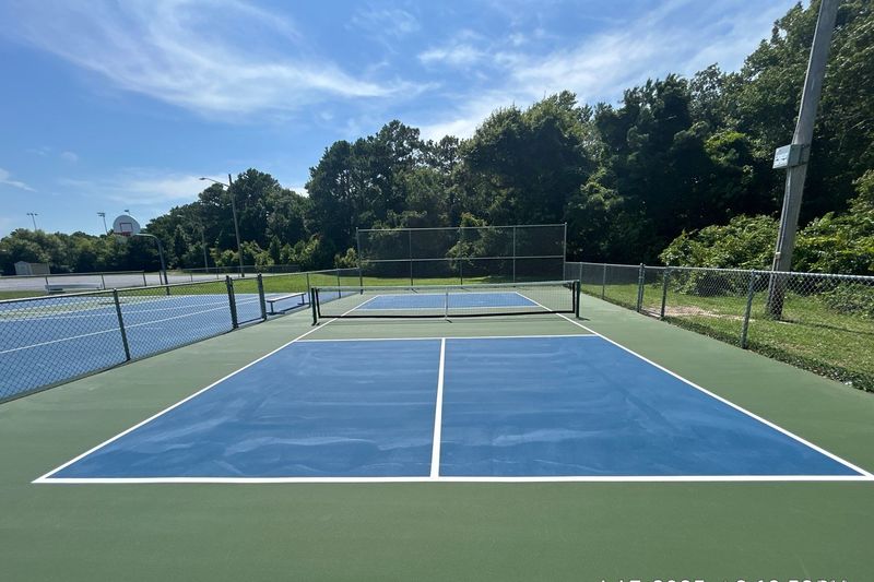 Blue tennis court seen from the corner