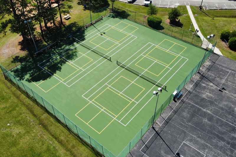 Angled aerial of the resurfaced courts beside the parking area