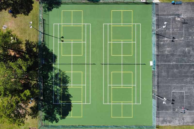 Straight-down aerial of two resurfaced courts