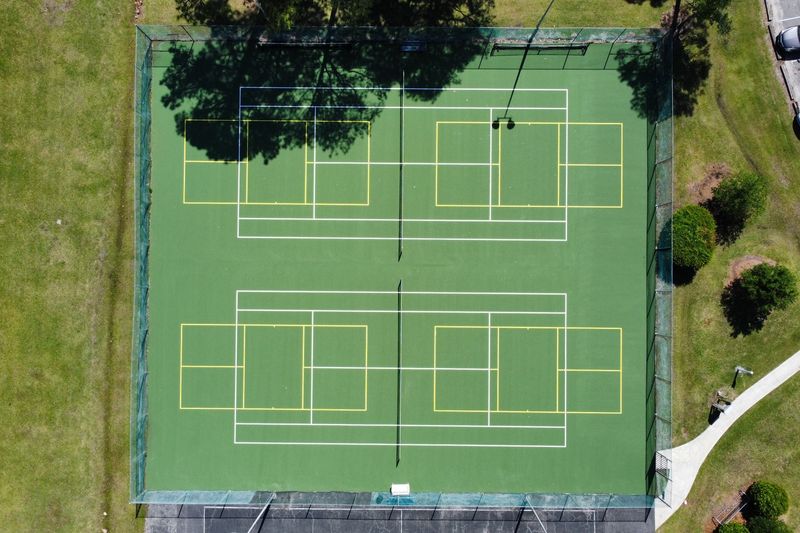 Aerial of the resurfaced courts with tree shadows