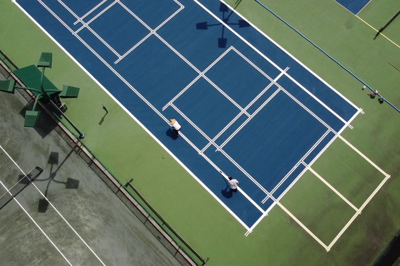 Angled drone view of dedicated pickleball courts with new nets
